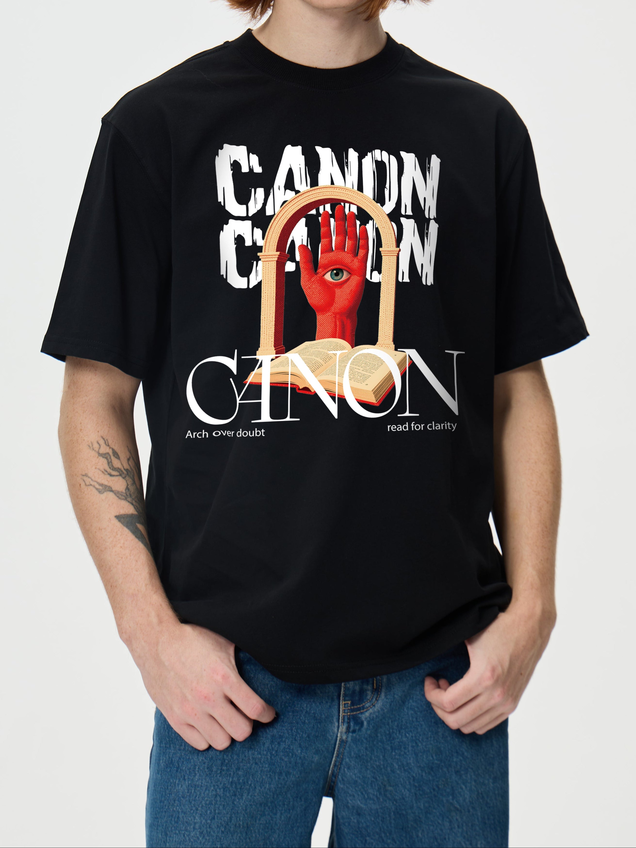 Person wearing a black t-shirt with 'Canon' graphic design on a white background